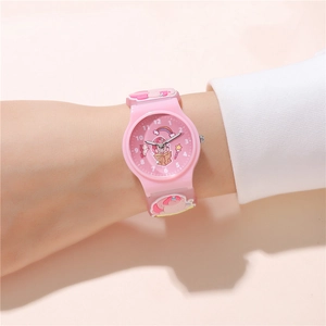 Detail of pink silicone watch band with 3D embossed cartoon unicorn and rainbow design