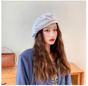 Close-up of sparkling iridescent sequins on a stylish white beret for women