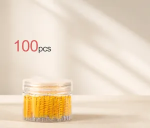 Jar of 100 yellow disposable mascara wands for eyelash and eyebrow grooming