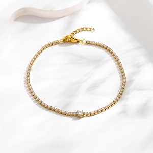 Detail of gold tennis bracelet with white round zircon and adjustable lobster clasp