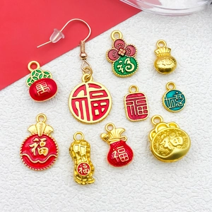 Close-up of golden Fu character charms with red enamel for DIY jewelry making