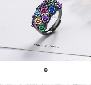 Macro shot of multi-color zircon crystals on a black plated adjustable ring band