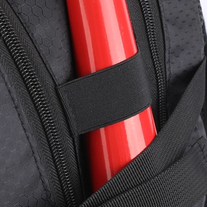 Close-up of waterproof fabric and elastic strap for securing a baseball bat on the backpack