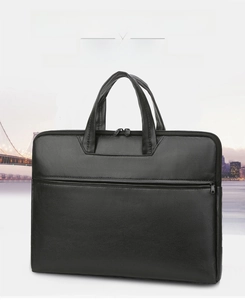 Close-up of matte black leather business briefcase featuring dual handles and front zipper