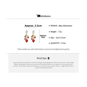 Detail showing vintage strawberry earrings size 6cm by 2.5cm with red enamel and rhinestones