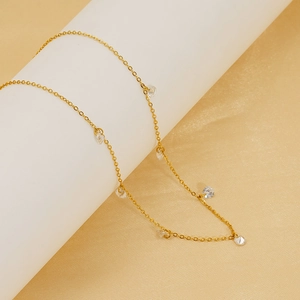 Detail of 18k gold plated titanium steel necklace with sparkling zircon charms