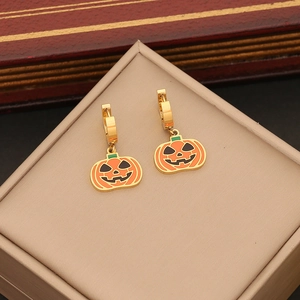 Detail of gold hoop earrings with orange pumpkin charms for Halloween jewelry sets