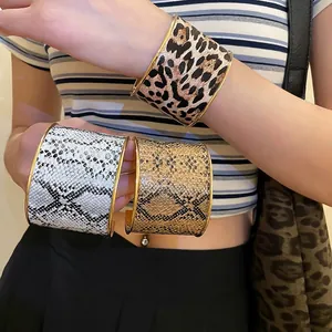 Three-piece set of animal print wide open cuff bracelets with gold trim finish