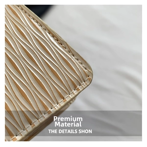 Detailed macro view of light brown Epi leather texture and neat white stitching on the bag
