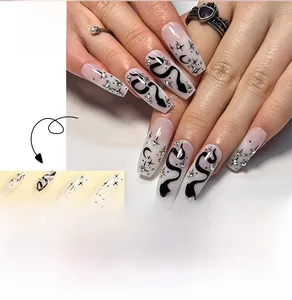 Macro detail of long coffin nails featuring snake patterns, starbursts, and colorful rhinestones