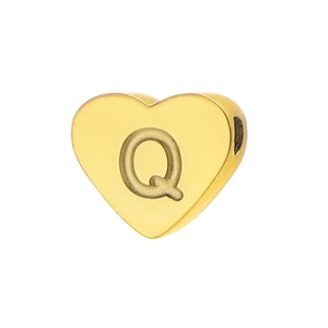Macro detail of gold-plated heart charm featuring engraved letter Q for DIY jewelry