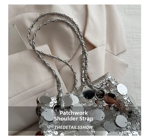 Macro detail of silver sequin bag featuring a metallic chain and leather patchwork strap