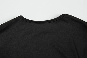 Detail shot of the breathable knitted crew neck and clean stitching on a black mini dress