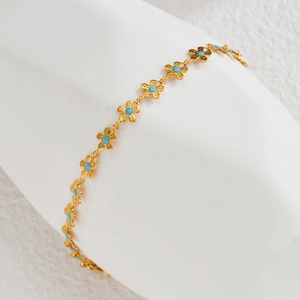 Elegant gold-plated stainless steel bracelet featuring blue floral charms in an INS style