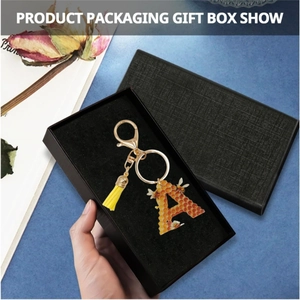 Detail of honey bee letter A keychain in gift box with yellow tassel and lobster clasp
