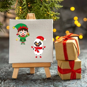 Mini Christmas canvas with cute elf and snowman on easel with red gift box and festive lights