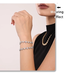Detail of 18k gold plated flower bracelet with zircons on model wrist