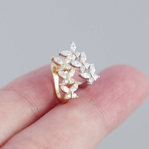 Macro shot of butterfly wing zircon stud earrings in gold and silver plating