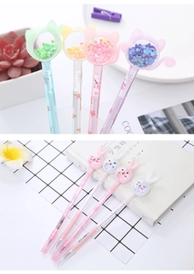 Detail of creative glitter pens with cartoon cat and rabbit tops and liquid-filled chambers