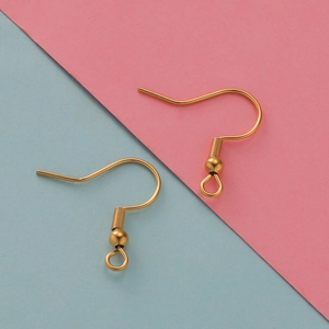 Macro view of golden stainless steel earring hooks with spring and ball for DIY jewelry