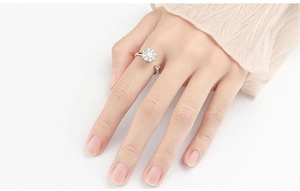 Detailed view of silver flower spinner ring for anxiety relief on a model hand