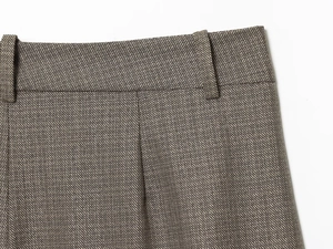 Detailed view of brown-gray woven suit pants waistline with belt loops and stitching