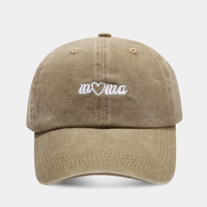 Detailed close-up of white Mama embroidery on khaki washed cotton baseball cap