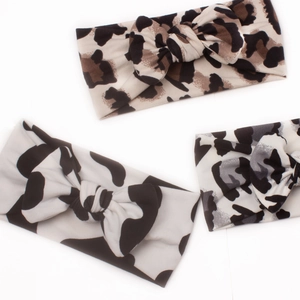 Three elastic knot baby headbands featuring leopard, cheetah, and cow animal prints