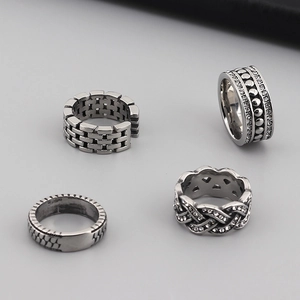 Collection of vintage silver stainless steel rings with unique textured arrow and leaf designs