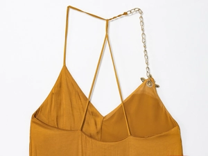 Close-up of ginger satin midi dress featuring delicate thin straps and gold metal chain link