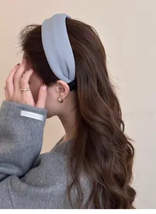 Detail of blue padded headband with matte fabric texture shown on model side profile
