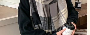 Detail of checkered scarf texture in beige and grey with cozy coffee shop aesthetic