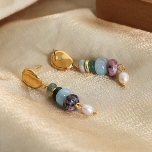 Bohemian dangle earrings with natural stones and freshwater pearls on silk background