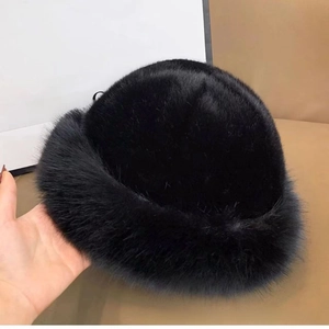 Detail of a thick black faux fur bucket hat with soft, fluffy texture for winter warmth