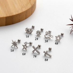 Detailed macro view of 8 assorted stainless steel cartilage studs with cubic zirconia