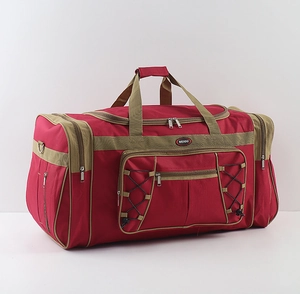 Detail view of red waterproof travel bag featuring reinforced handles and elastic mesh pocket