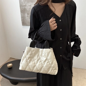Fashionable white quilted puffer tote bag with black strap handles for women's daily commute