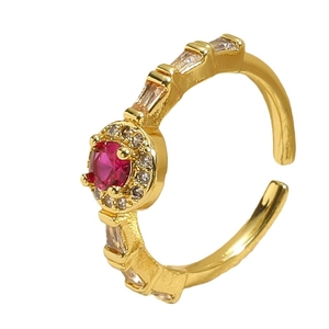 Golden open ring featuring a round red gemstone surrounded by sparkling white zircons