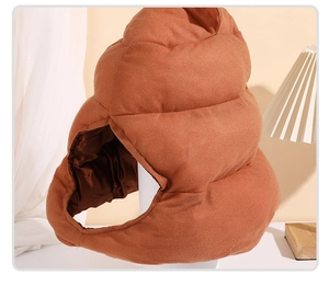 Detail of plush funny poop-shaped hat with soft brown material and inner lining