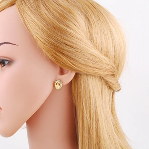 Detailed close-up of Virgin Mary stud earrings with colorful zircons on a model