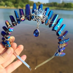 Macro shot of blue raw crystals and silver sun pendant on a handmade wizard crown