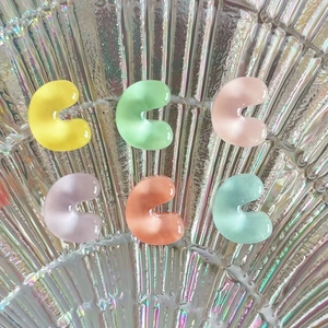 Colorful C-shaped resin alphabet charms with a translucent jelly finish for DIY crafts