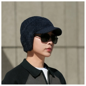 Detailed side view of navy blue knit ear protection hat for men with warm lining
