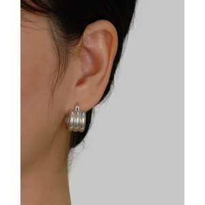 Close-up of minimalist S925 silver triple hoop earrings worn on a model's ear