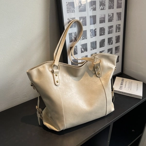 Large beige PU leather tote bag with gold hardware and adjustable straps for daily use