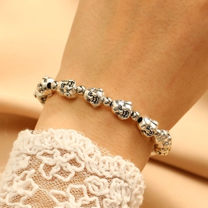 Close-up of vintage silver laughter Buddha beads on a beaded ethnic style bracelet