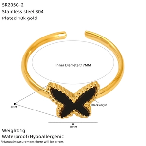 Macro detail of 18K gold plated butterfly charm on adjustable stainless steel ring