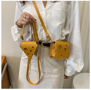 Mini yellow cheese-shaped crossbody bag shown on a model with white outfit