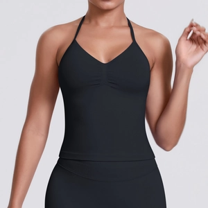 Detail of a black seamless yoga vest with halter neck and deep V-neckline on female model