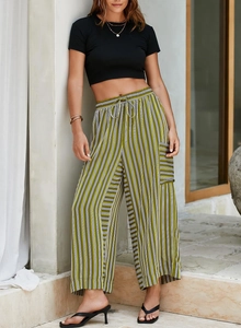 Detail of high-waist green and white striped wide-leg trousers with relaxed fit and drawstring